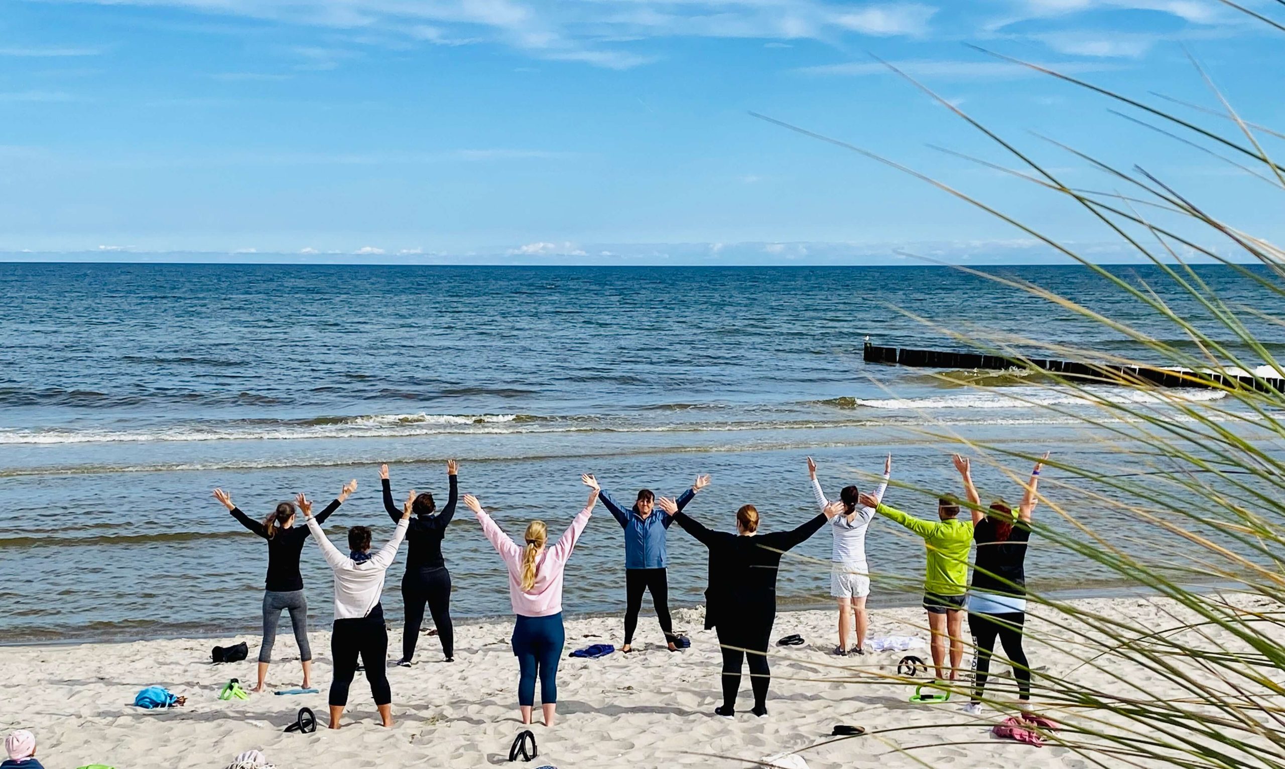 Gruppe von Patienten bei einer Gymnastikübung am Ostseestrand